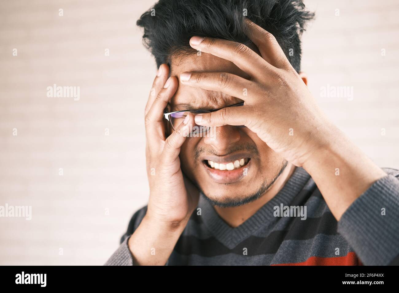 Close up of sad man covering face with hand Stock Photo - Alamy