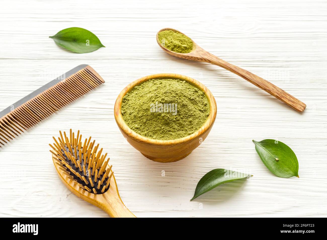 Henna powder in wooden bowl with green leaves. Herbal natural hair dye  Stock Photo - Alamy