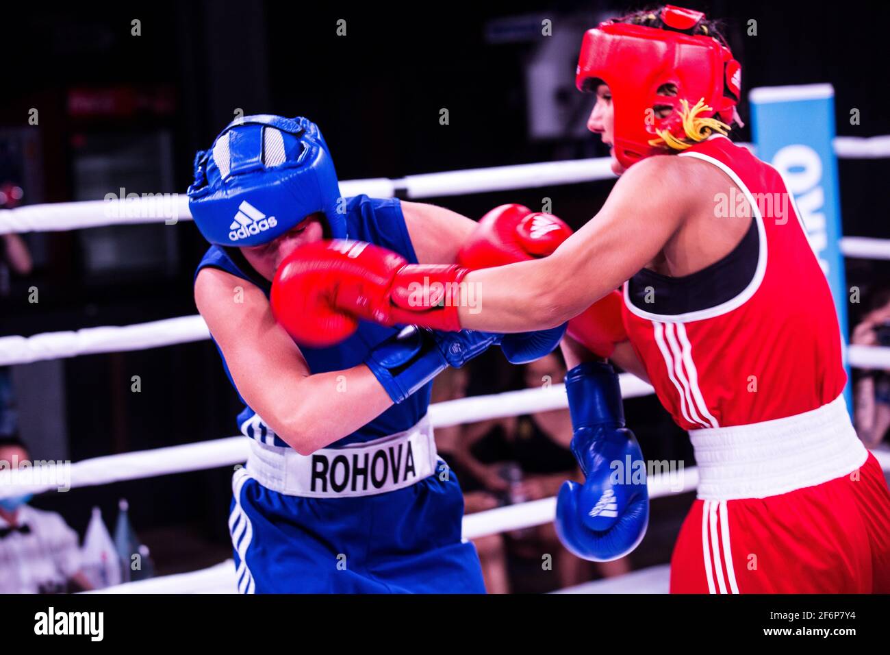 Ukraine's flyweight southpaw female talent Lera Yeroshenko (right in red uniform) rocks with solid left hook master Katia Rogova then wins the fight Stock Photo