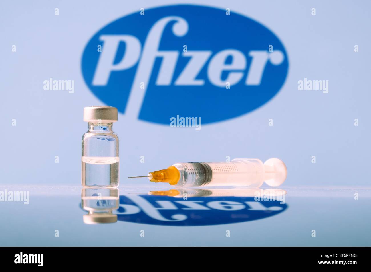 Pfizer Coronavirus Vaccine vial and syringe with logo as background. LJUBLJANA, SLOVENIA: March 25, 2021 Stock Photo