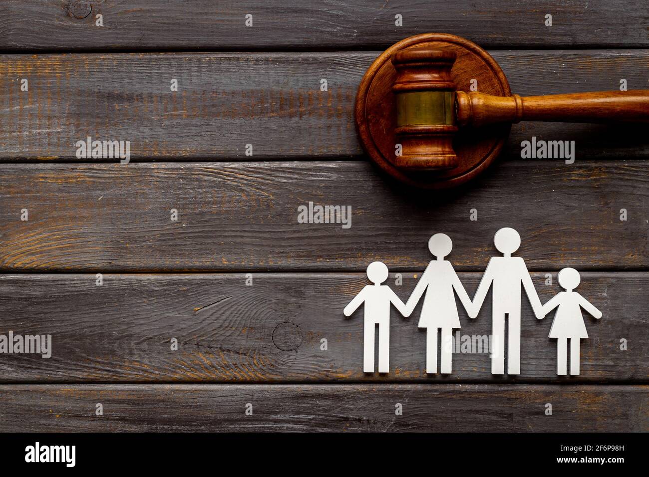 Family law or divorce concept. Family figure with judge gavel, top view