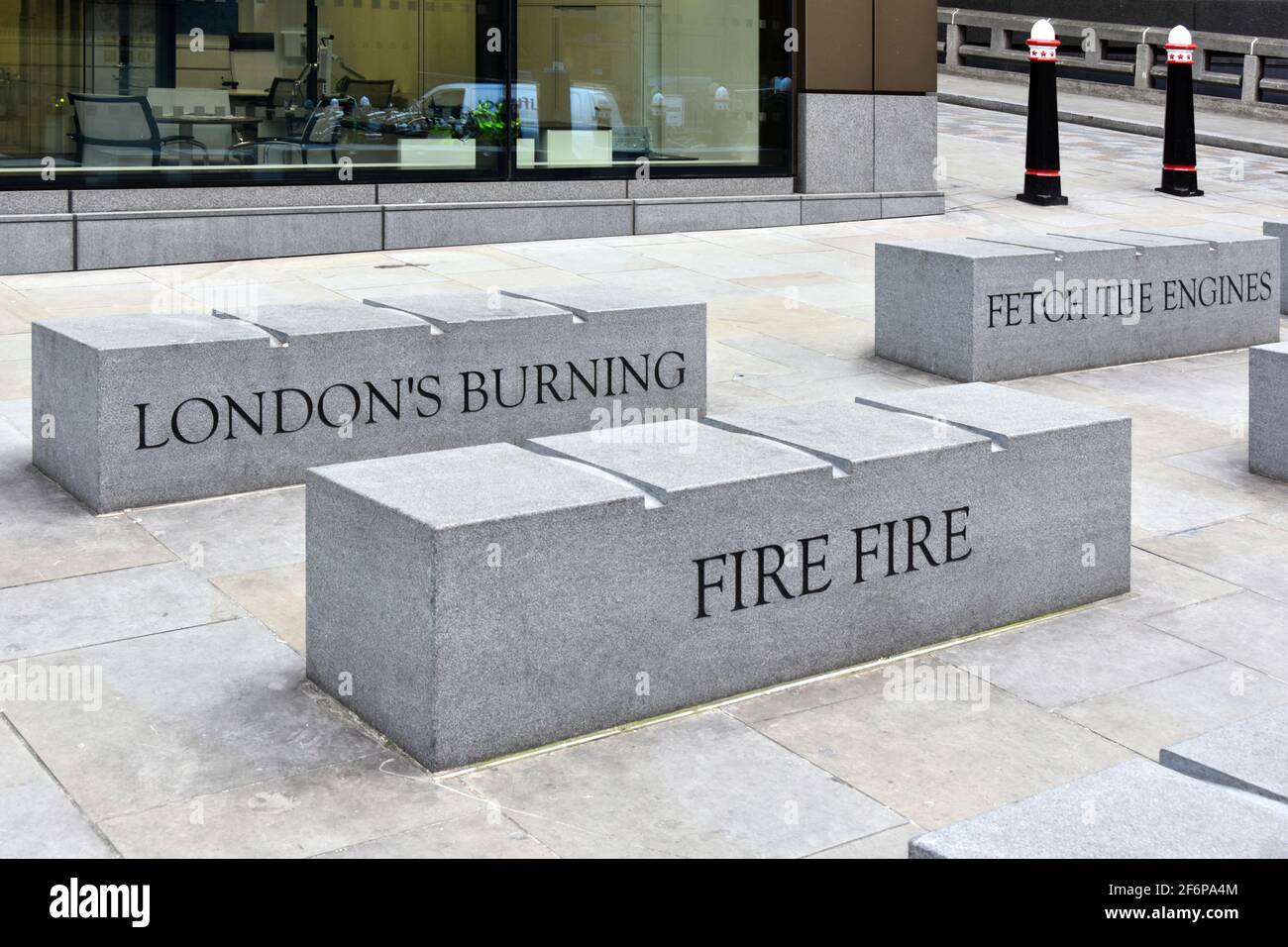 Large granite stone bench seat & engraved quotations from popular childs poem about Great Fire of London located beside Monument column in London UK Stock Photo