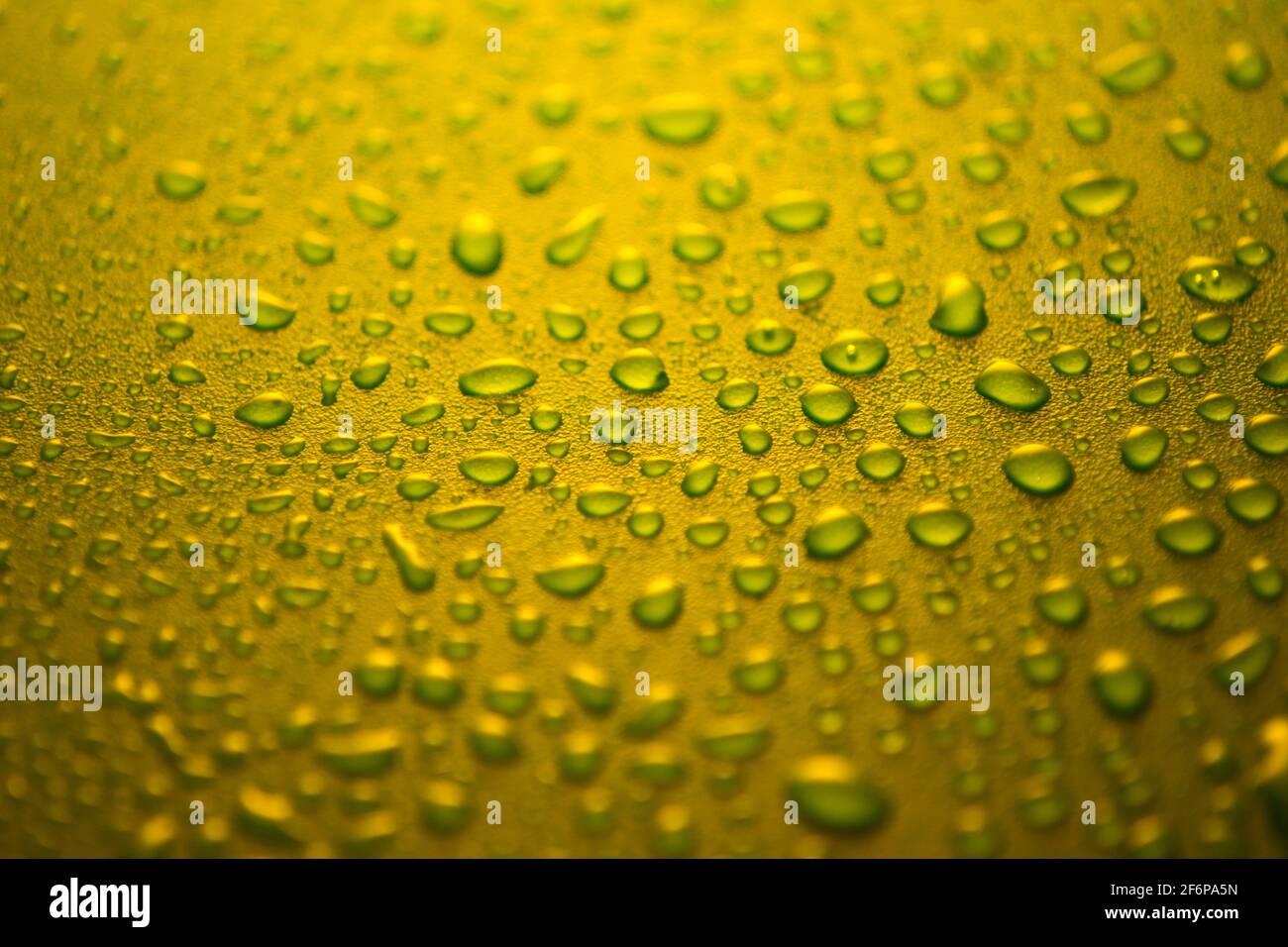 water drops on a plastic yellow background in the dark Stock Photo - Alamy