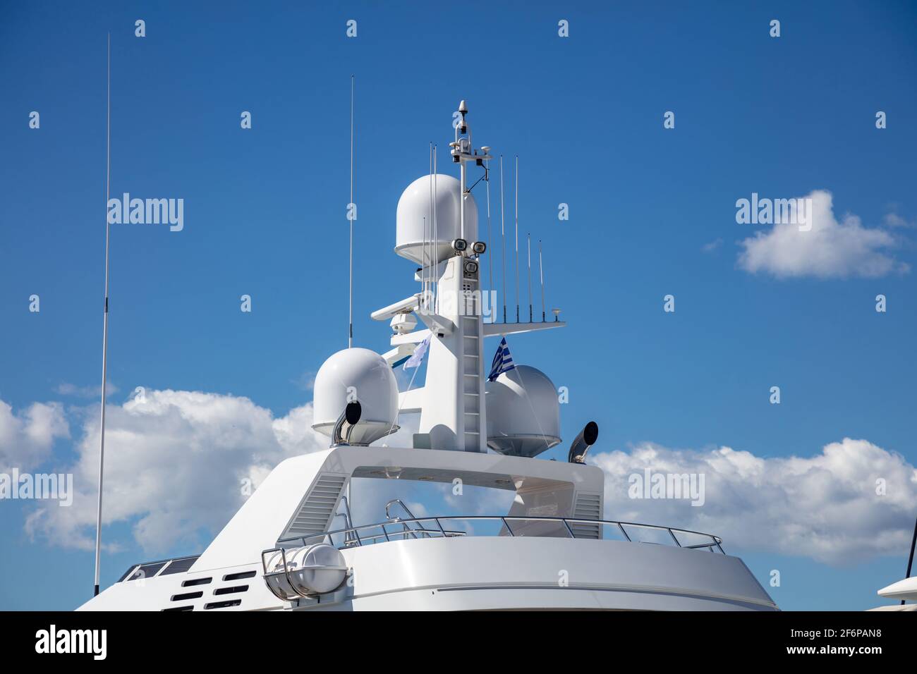 Yacht navigation equipment concept. Luxury rooftop, satellite radar, antenna, technical support, wireless transmission, safe shipping, under Greek blu Stock Photo