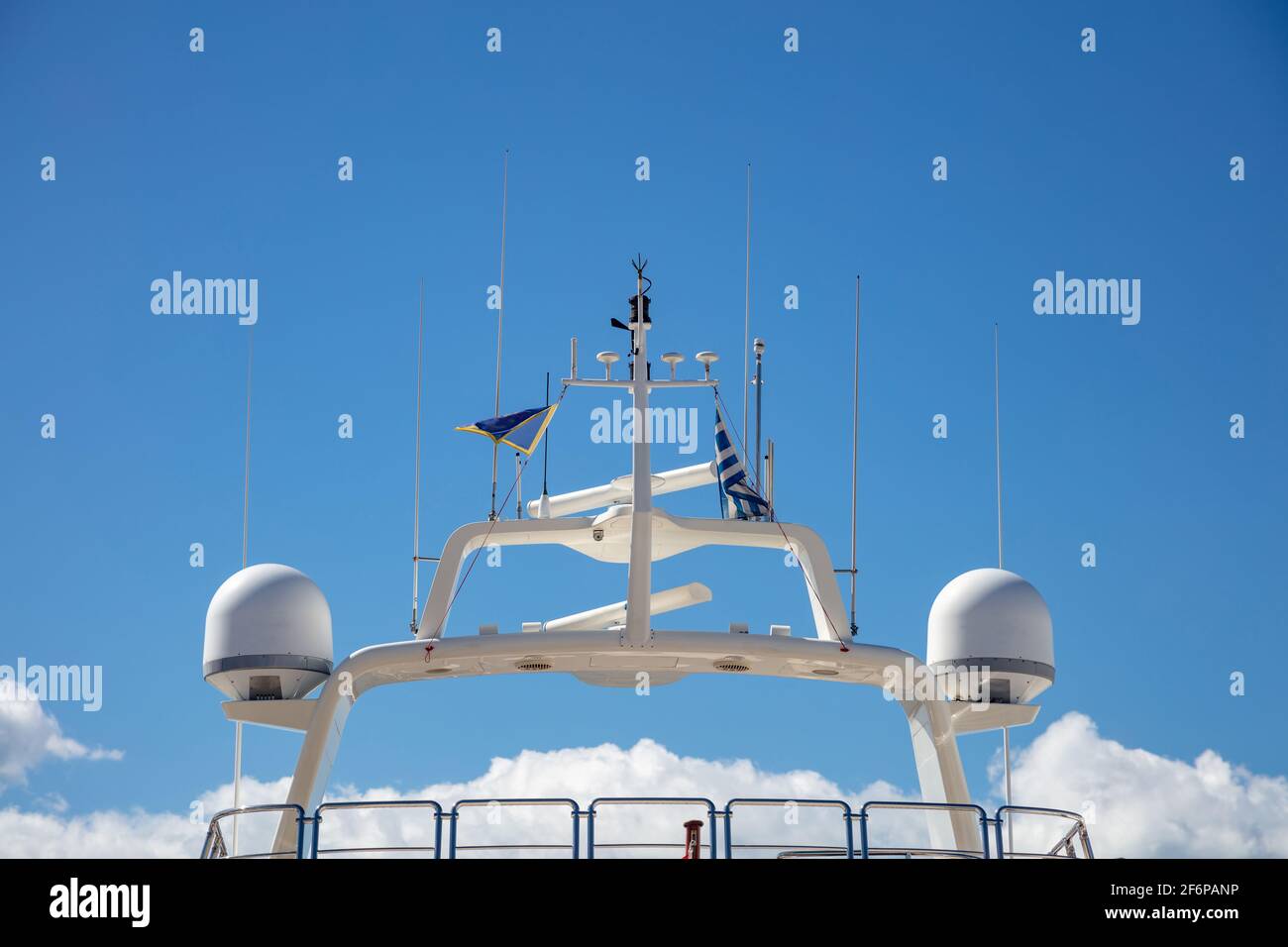 Navigation equipment concept. Luxury yacht rooftop, satellite radar, antennas, technical support, wireless transmission, safe sea shipping, under Gree Stock Photo