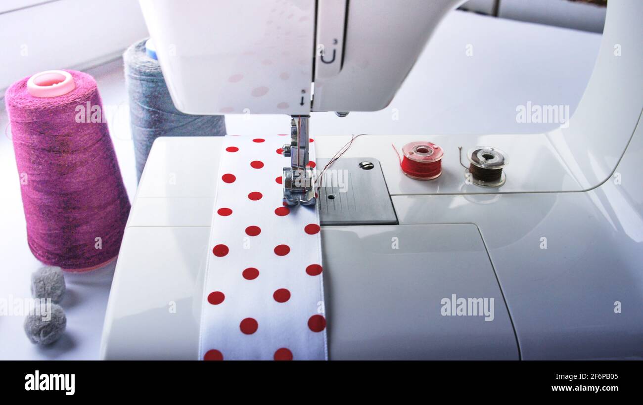 electric sewing machine with thread, bobbin and ribbon Stock Photo - Alamy