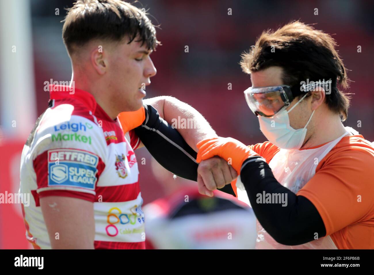 Leigh Centurions' Keanan Brand (left) receives treatment for an injury during the Betfred Super League match at The Totally Wicked Stadium, St Helens. Picture date: Friday April 2, 2021. Stock Photo