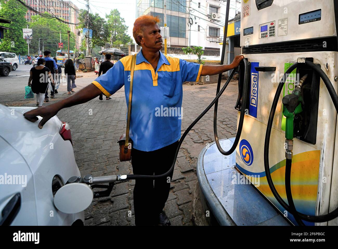 Kolkata, India. 02nd Apr, 2021. A petrol pump worker refills a car at a