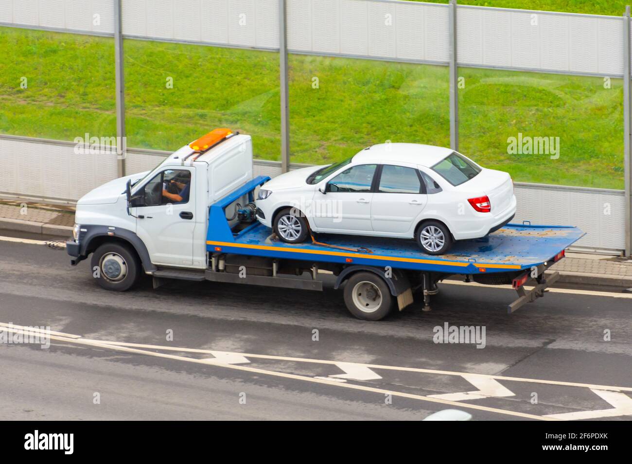Towing service the tow truck with the loaded old damaged car which