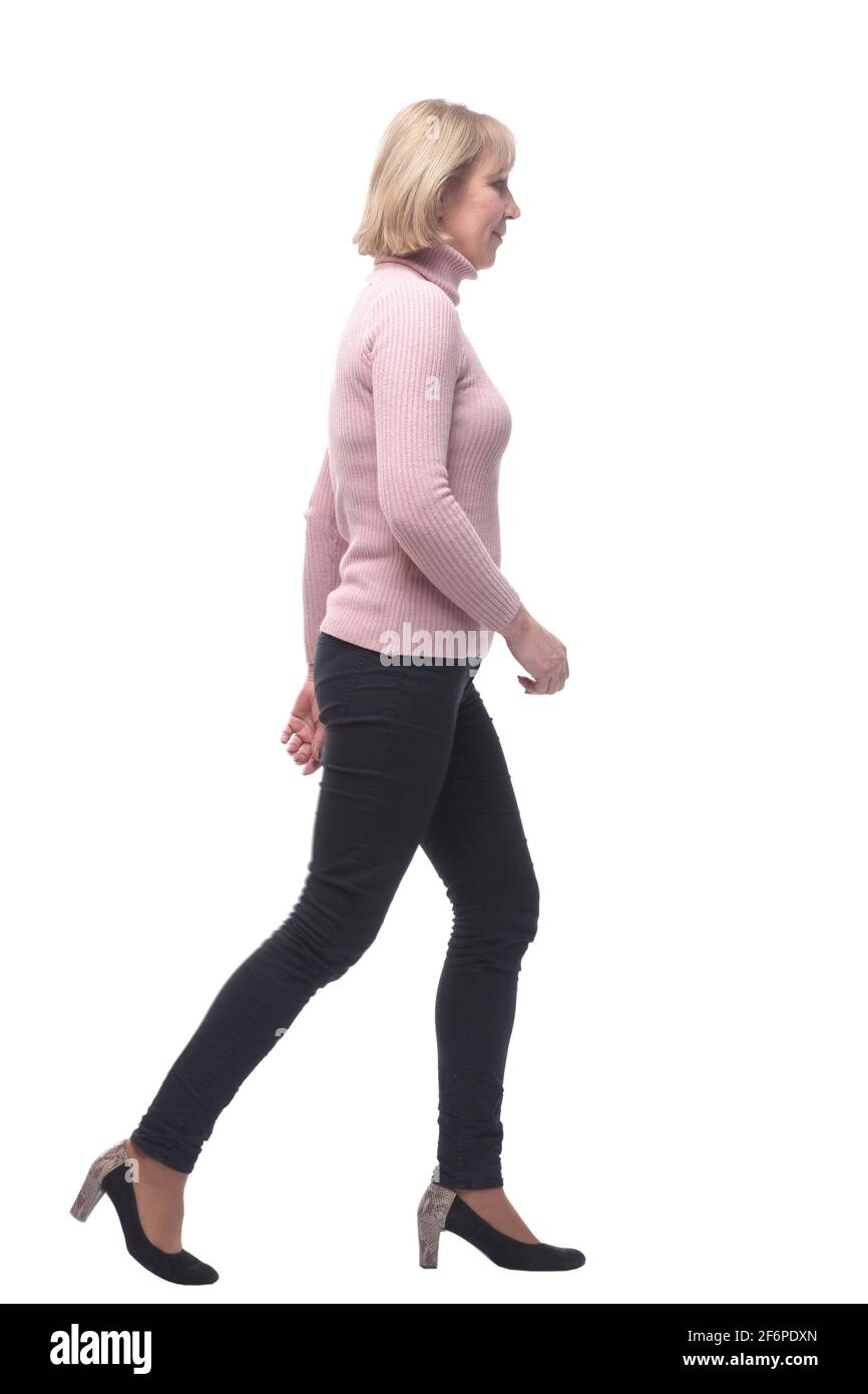 Side view of a casual woman walking away from the camera and smiling Stock Photo