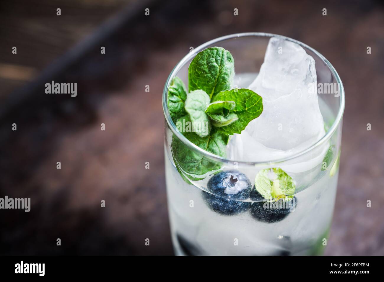 Blueberry mojito cocktail on the wooden background. Selective focus. Shallow depth of field. Stock Photo