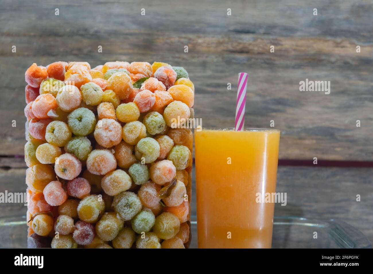 Acerola juice (Malpighia emarginata) and frozen fresh acerola fruits