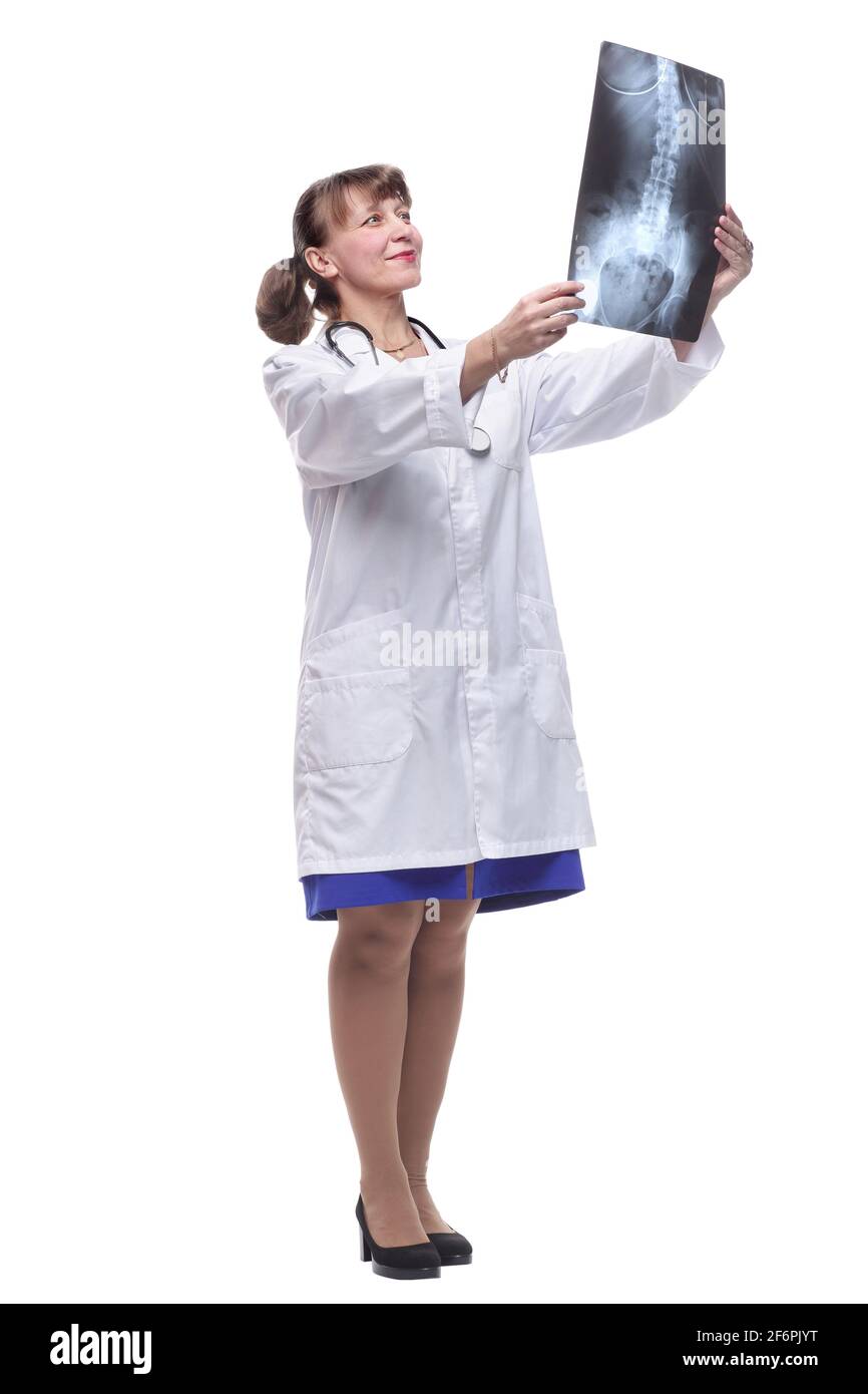 Attractive female nurse or doctor wearing lab coat and stethoscope reviewing an X-ray Stock Photo
