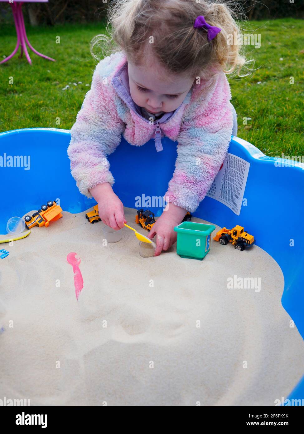 Toddler playing in a sand pit, UK Stock Photo Alamy