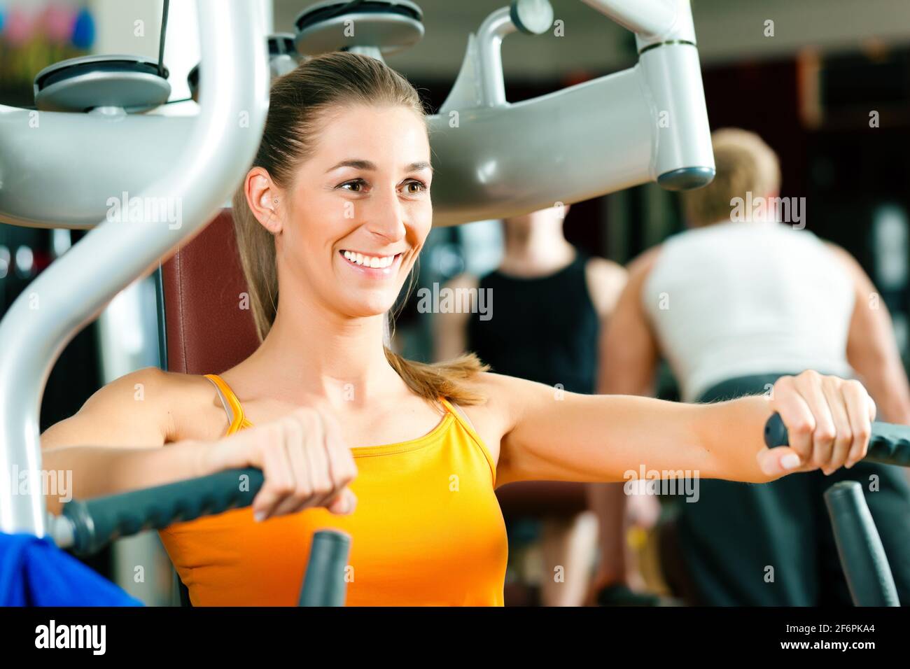 Woman doing fitness training on a butterfly machine with weights