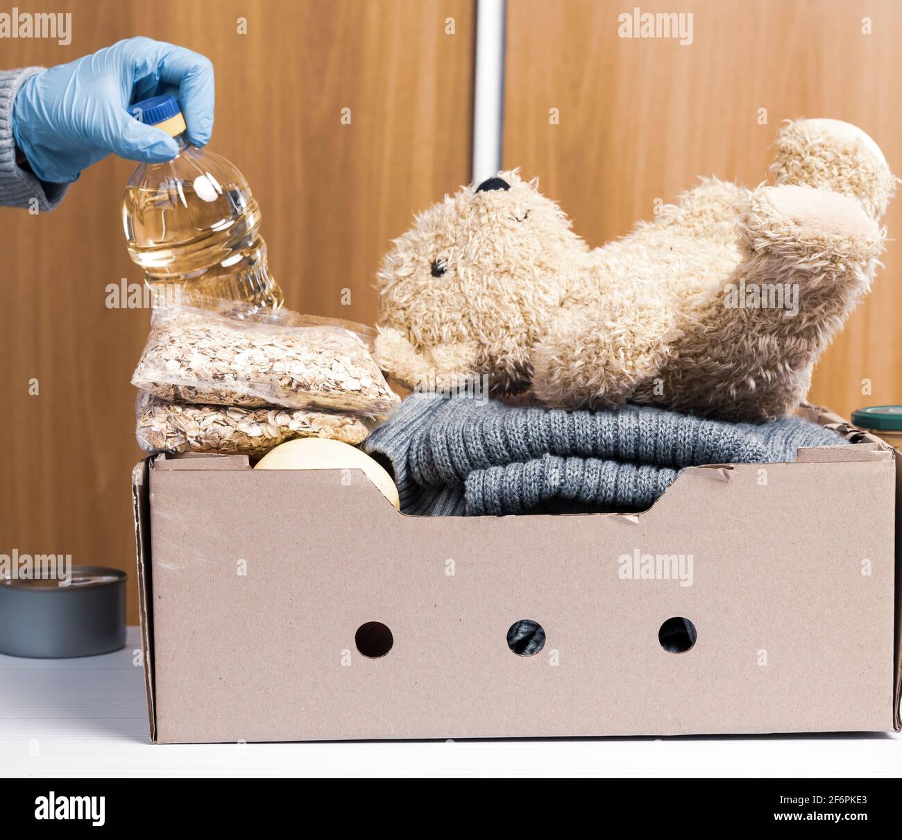 cardboard box with food and things to help those in need, help concept ...