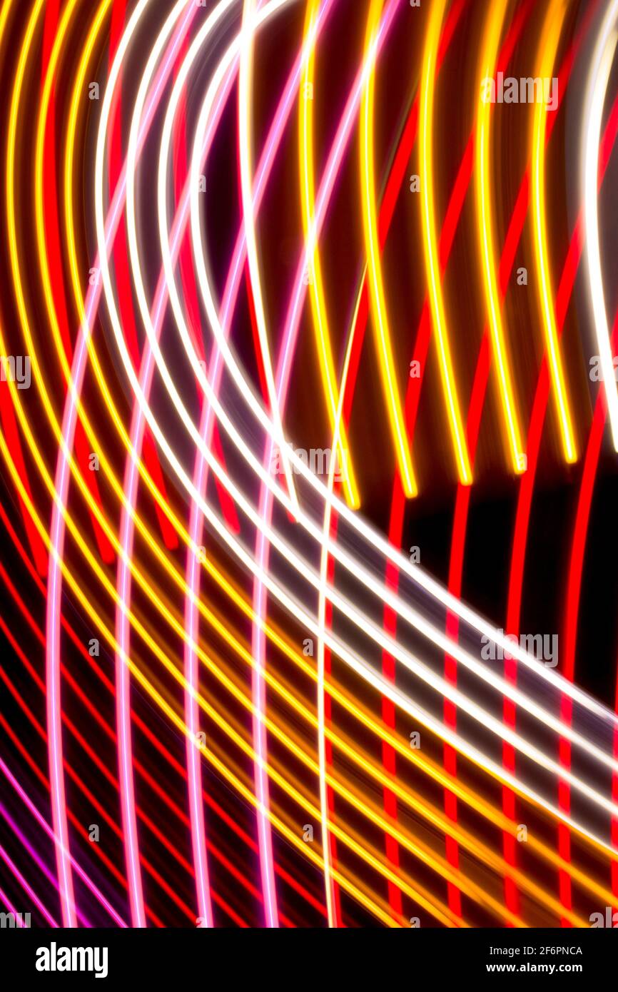 Yellow, red and pink light curve lines on a black background Stock ...