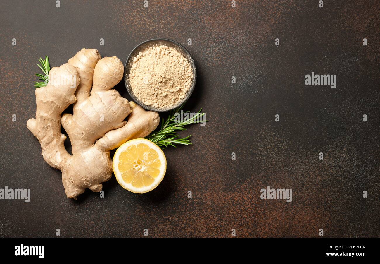 Ginger root, ginger powder and lemon on vintage background Stock Photo
