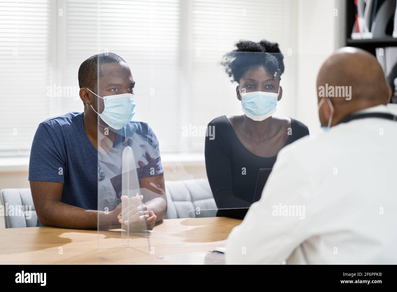 Couple Patient At Doctor With Pregnancy Lab Test Results Stock Photo