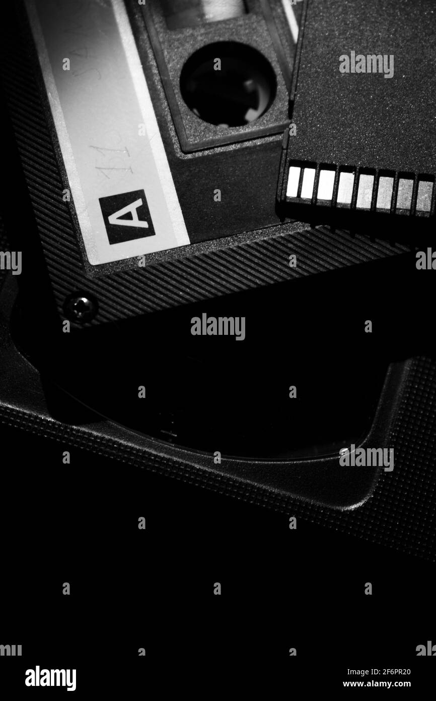VHS cassette, audio cassette and SD card shot close up on a dark