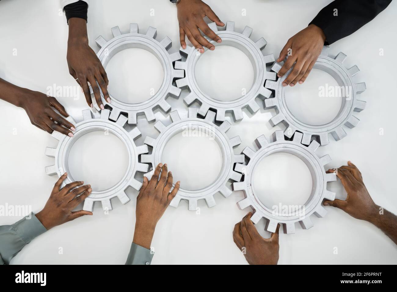 Business People Team Hands Connecting Gears. Implementation And Collaboration Stock Photo