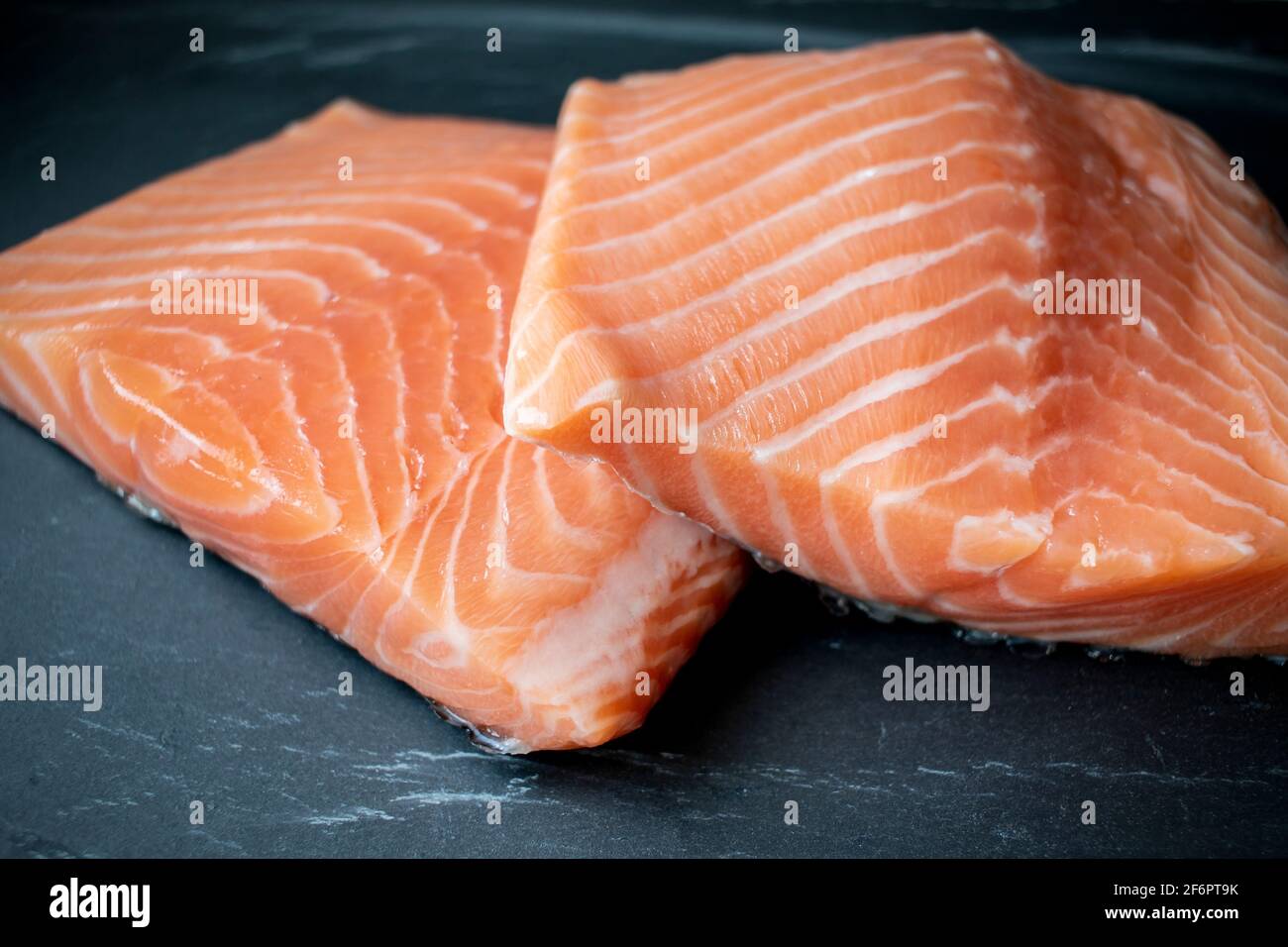 iFresh Salmon fillet on black stone background Stock Photo - Alamy