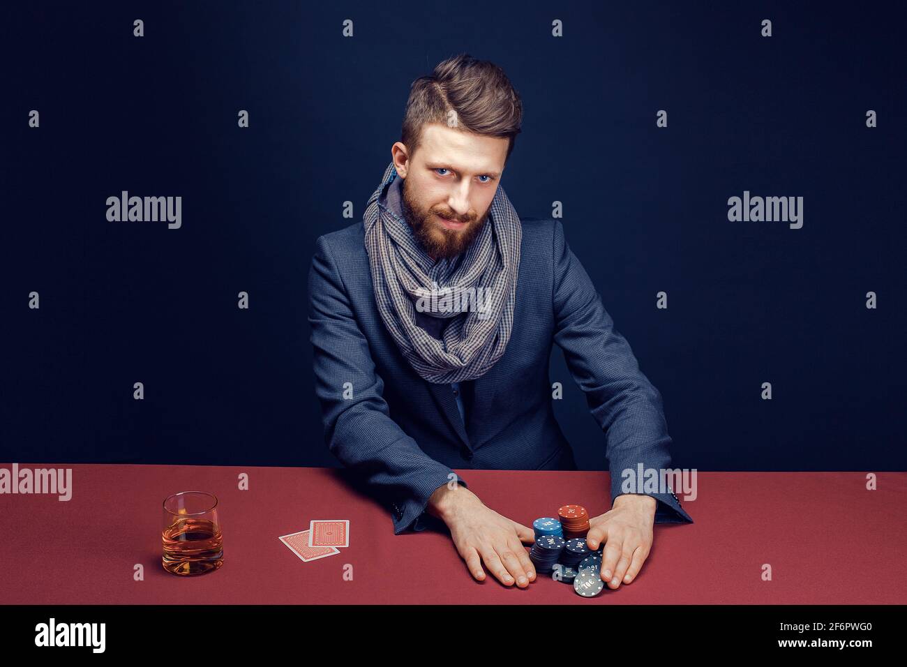 Premium Photo  Stylish bearded man in suit and scarf playing in dark casino
