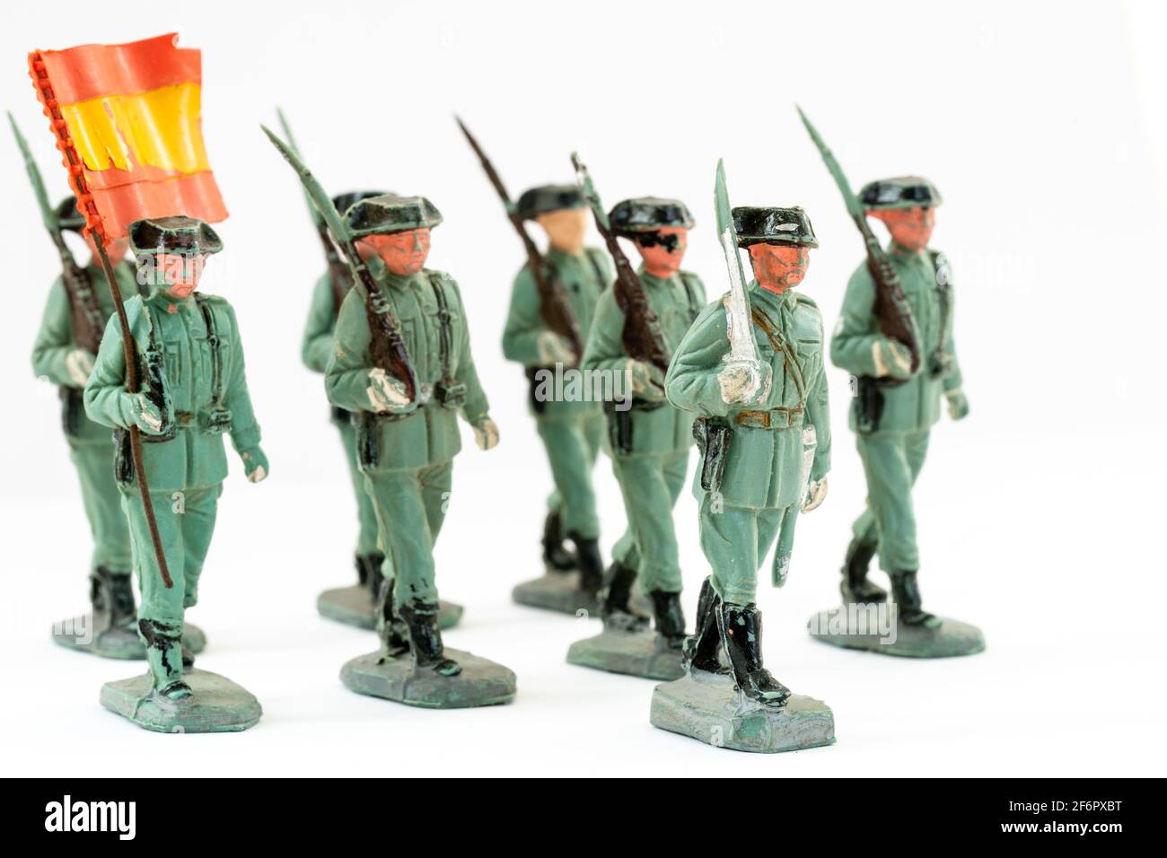 Reamsa Spanish Guardia Civil, Civil Guard plastic toy figures. Several marching with office at the front shouldering a sword, and flag bearer behind. Stock Photo