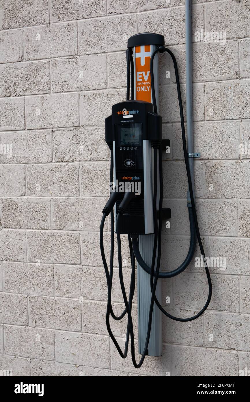 An EV charging station, for charging electric vehicles, on the side of a building in Speculator, NY USA Stock Photo
