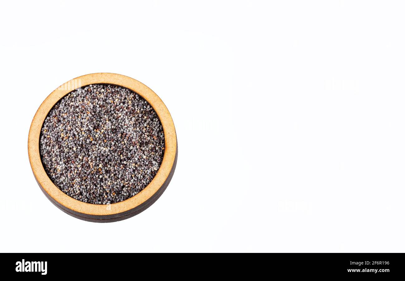 Organic poppy seeds in the wooden bowl - White background Stock Photo