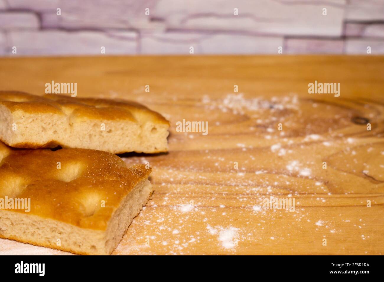 Italian Focaccia bread on a table with flour Stock Photo