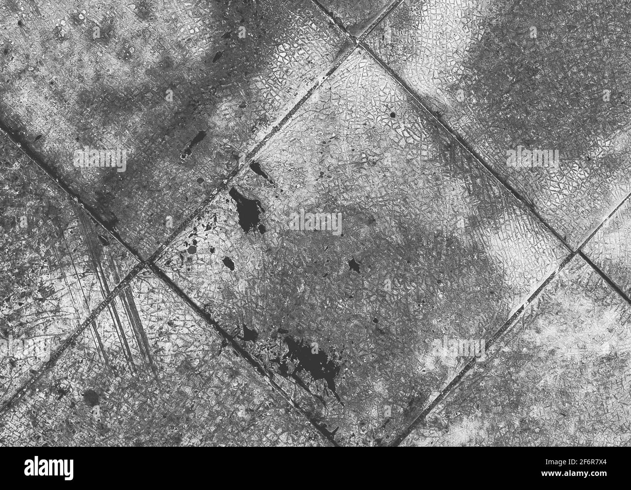Old black and white tile background, dirty cracked dark gray texture