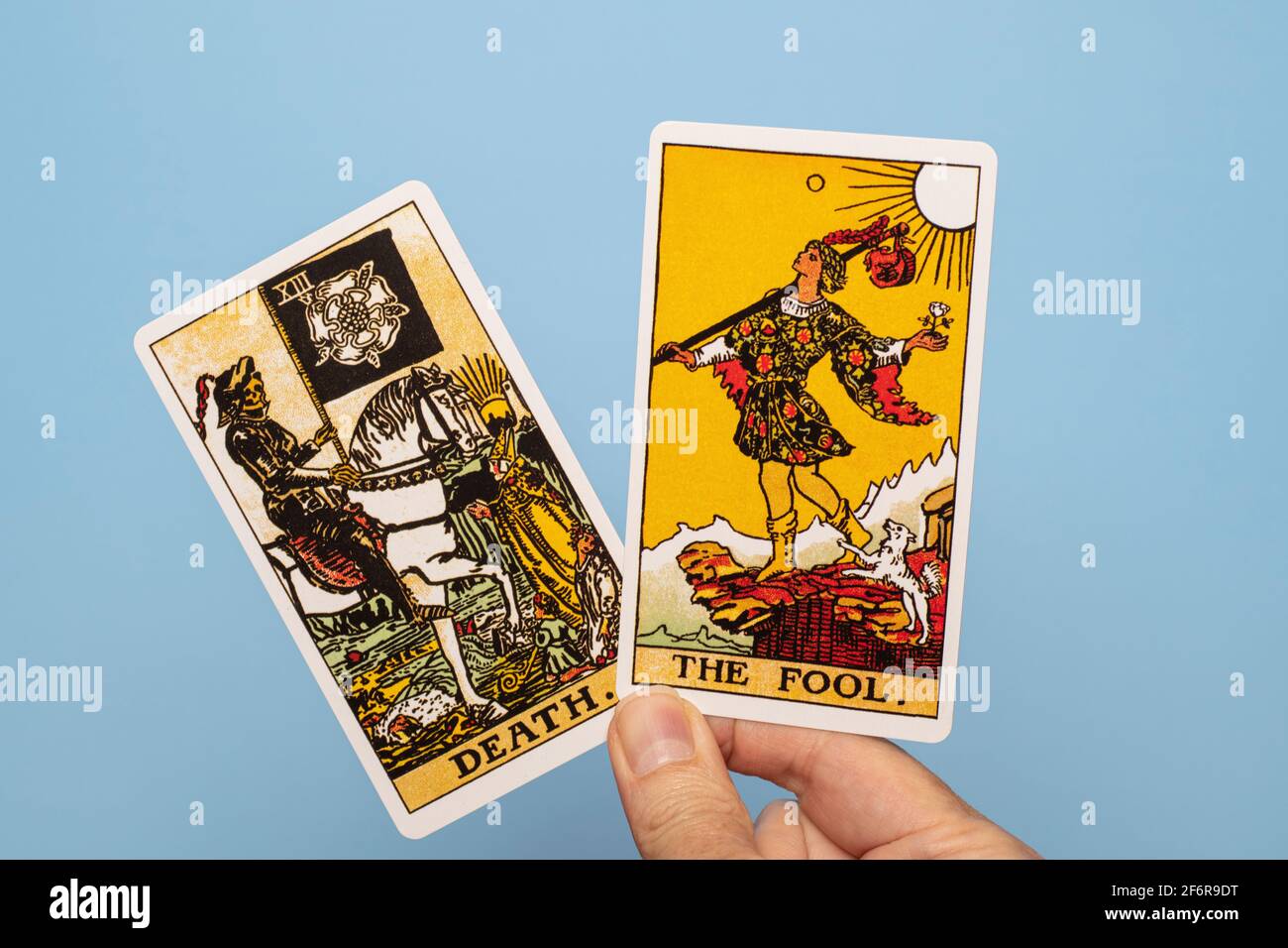 Hand holding two tarot cards, Death and The Fool Stock Photo