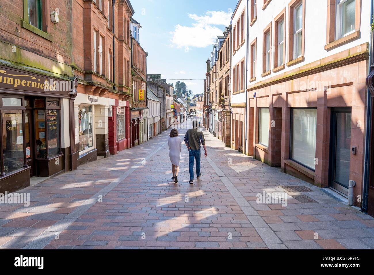 Dumfries, Scotland, UK. 2 April 2021. On the day when Scottish Government relaxes lockdown rules from “Stay at Home” to “Stay Local” the shopping streets of Dumfries town centre remain almost deserted with virtually no shops or businesses trading. Pic; Friars Vennel is lined with shops and cafes but is almost deserted on Friday afternoon because none are open. Iain Masterton/Alamy Live News Stock Photo
