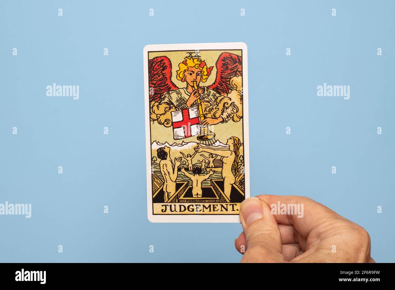 Hand holding the Judgement Tarot card Stock Photo