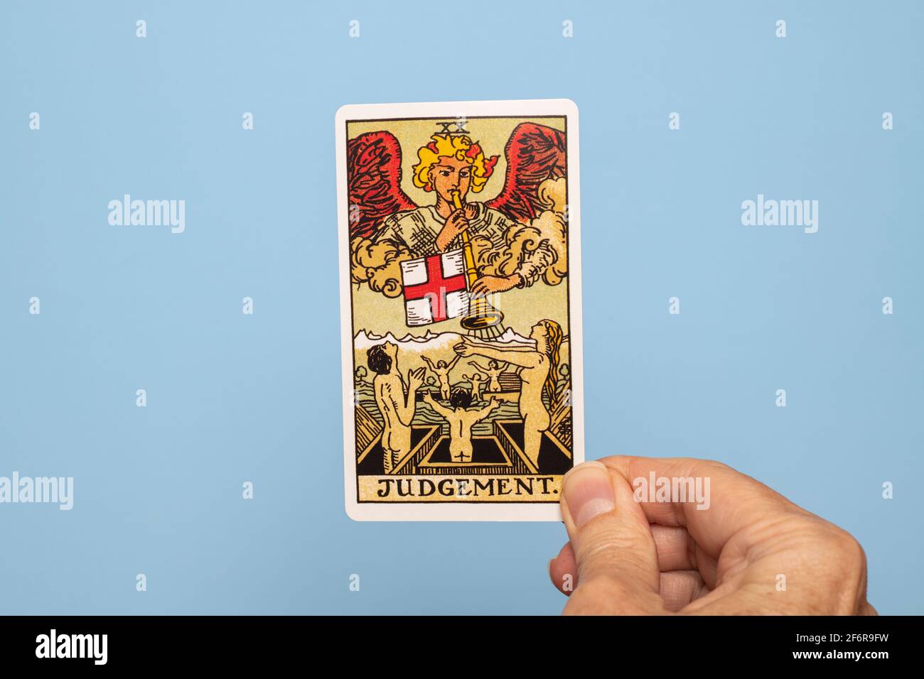 Hand holding the Judgement Tarot card Stock Photo Alamy