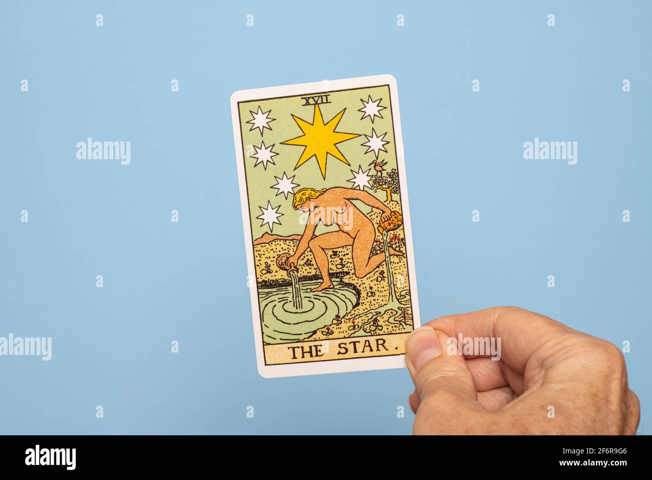 Hand holding The Star Tarot card Stock Photo