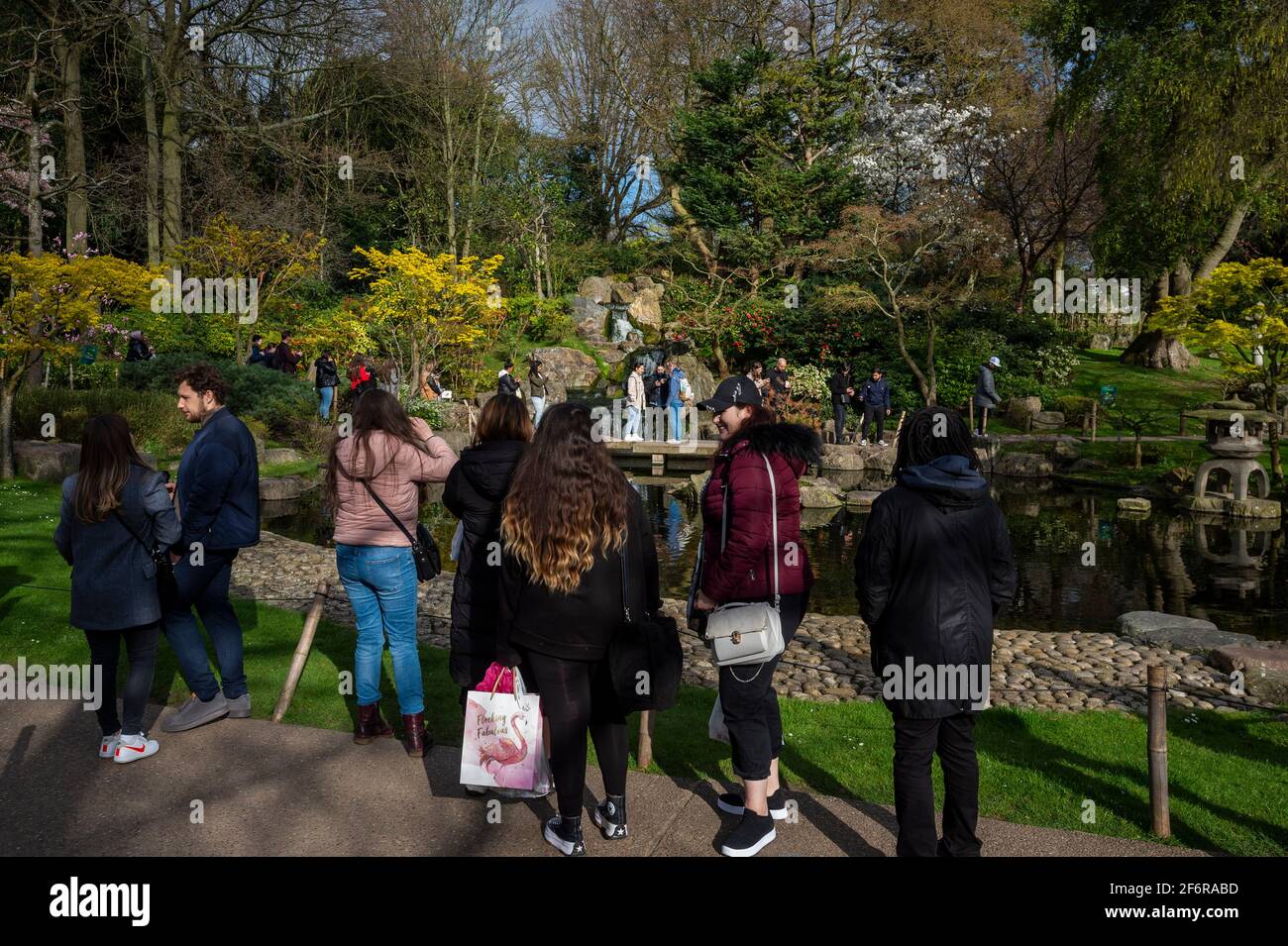 London, UK.  2 April 2021.  UK Weather:  People visit the Kyoto Garden in Holland Park, west London on Good Friday. Usually, the garden is quiet but as it is a public holiday and with lockdown restrictions slightly eased this week, many people have taken to the parks to enjoy the warmer conditions.   Credit: Stephen Chung / Alamy Live News Stock Photo