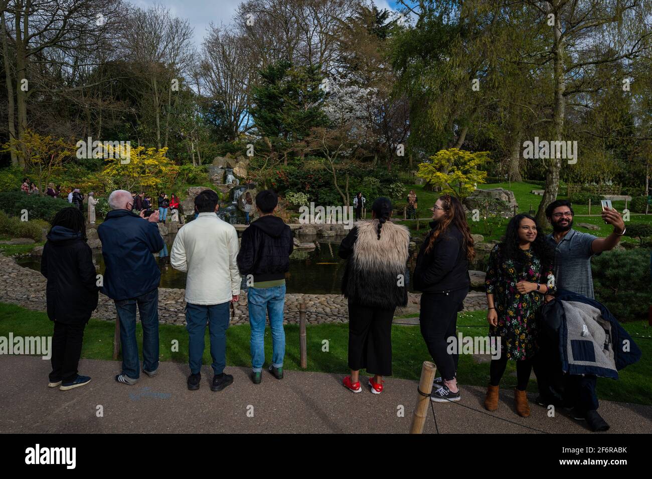 London, UK.  2 April 2021.  UK Weather:  People visit the Kyoto Garden in Holland Park, west London on Good Friday. Usually, the garden is quiet but as it is a public holiday and with lockdown restrictions slightly eased this week, many people have taken to the parks to enjoy the warmer conditions.   Credit: Stephen Chung / Alamy Live News Stock Photo