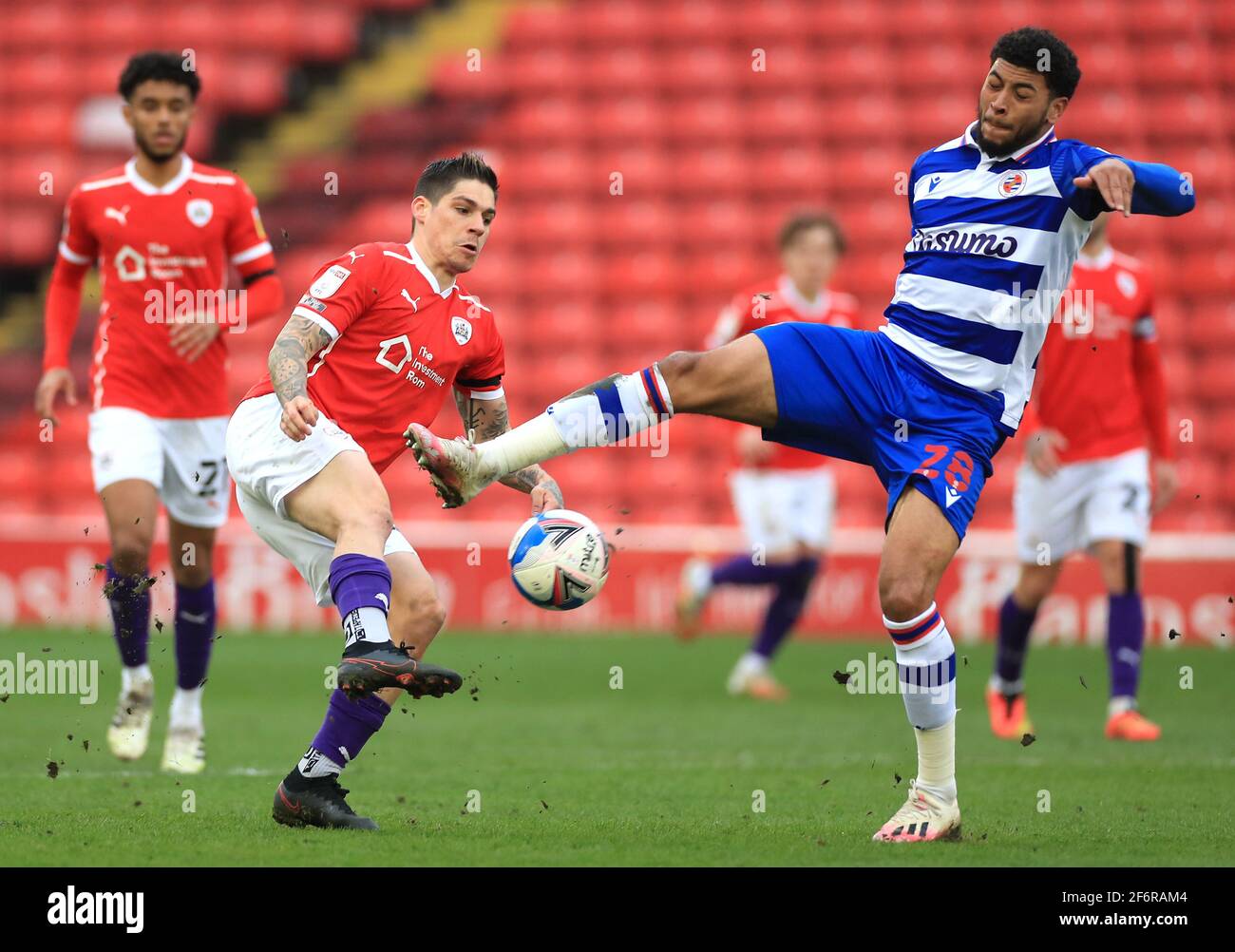 Reading's Josh Laurent (right) and Barnsley's Isaac Christie-Davies battle for the ball during the Sky Bet Championship match at Oakwell Stadium, Barnsley. Picture date: Friday April 2, 2021. See PA story: SOCCER Barnsley. Photo credit should read: Mike Egerton/PA Wire. RESTRICTIONS: EDITORIAL USE ONLY No use with unauthorised audio, video, data, fixture lists, club/league logos or 'live' services. Online in-match use limited to 120 images, no video emulation. No use in betting, games or single club/league/player publications. Stock Photo