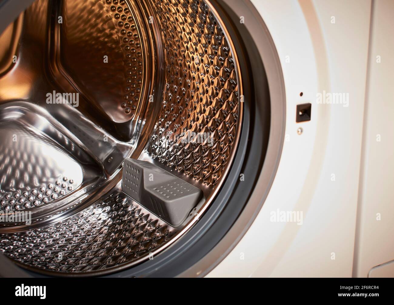 Empty drum of an automatic washing machine in bright colors Stock Photo