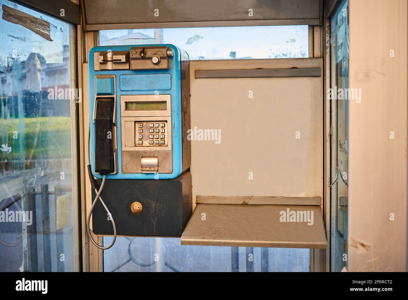 Telephone from an old telephone booth installed in a city Stock Photo