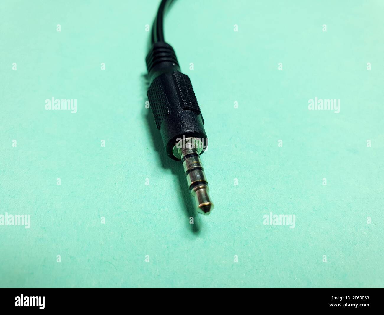 mini jack plug close up on green background Stock Photo