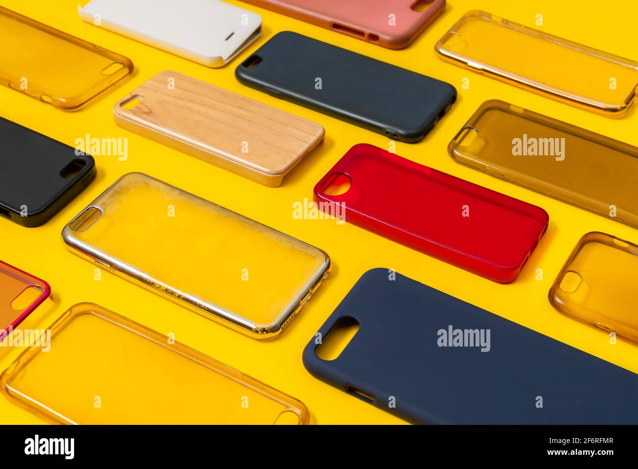 Pile of multicolored plastic back covers for mobile phone. Choice of smart  phone protector accessories on yellow background. A lot of silicone phone b  Stock Photo - Alamy