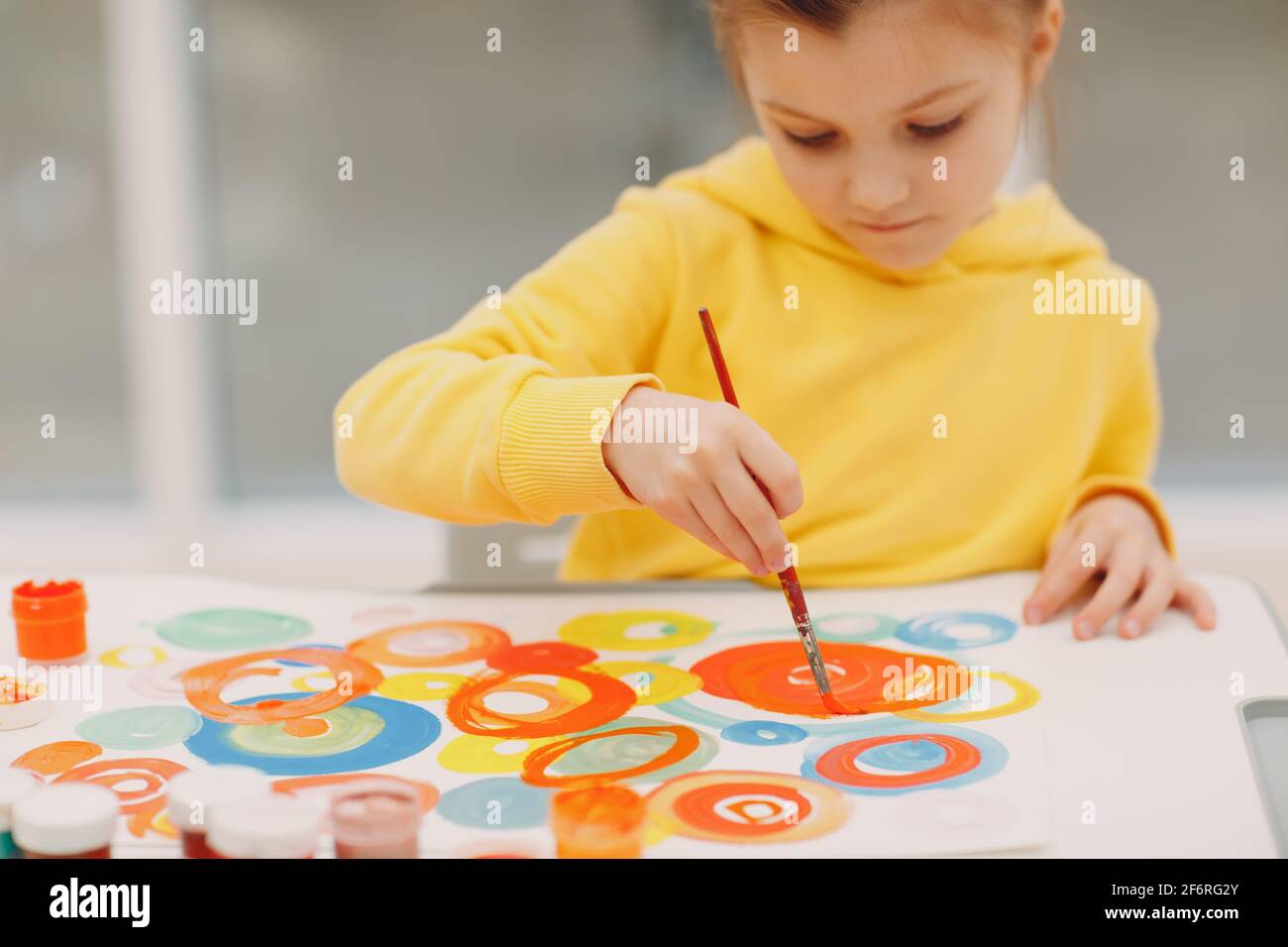 Little girl drawing art picture. Painting with brush and gouache paints ...
