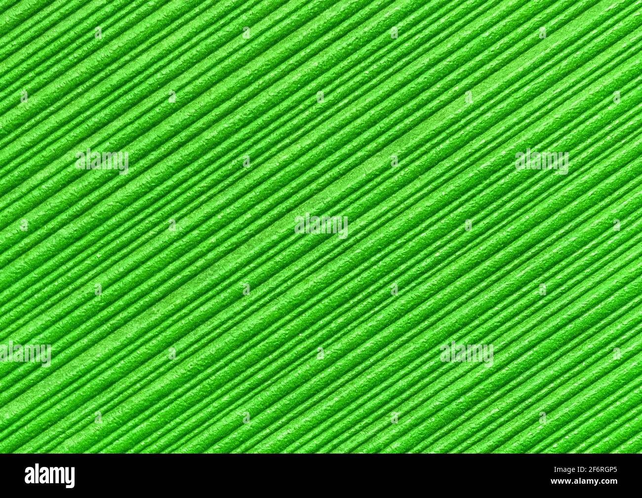Green abstract striped pattern wallpaper background, paper texture with diagonal lines. Stock Photo