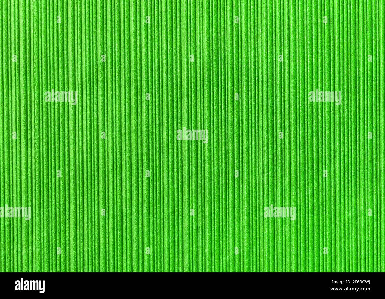 Green abstract striped pattern wallpaper background, paper texture with vertical lines. Stock Photo