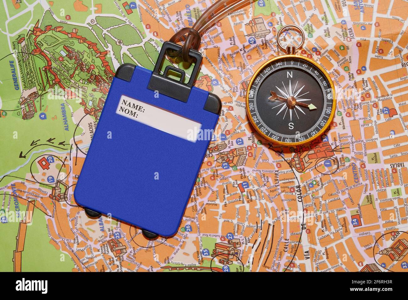 Compass and luggage label over map Stock Photo