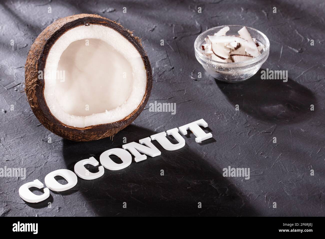 Grated coconut Cocos nucifera. Word coconut in letters Stock Photo