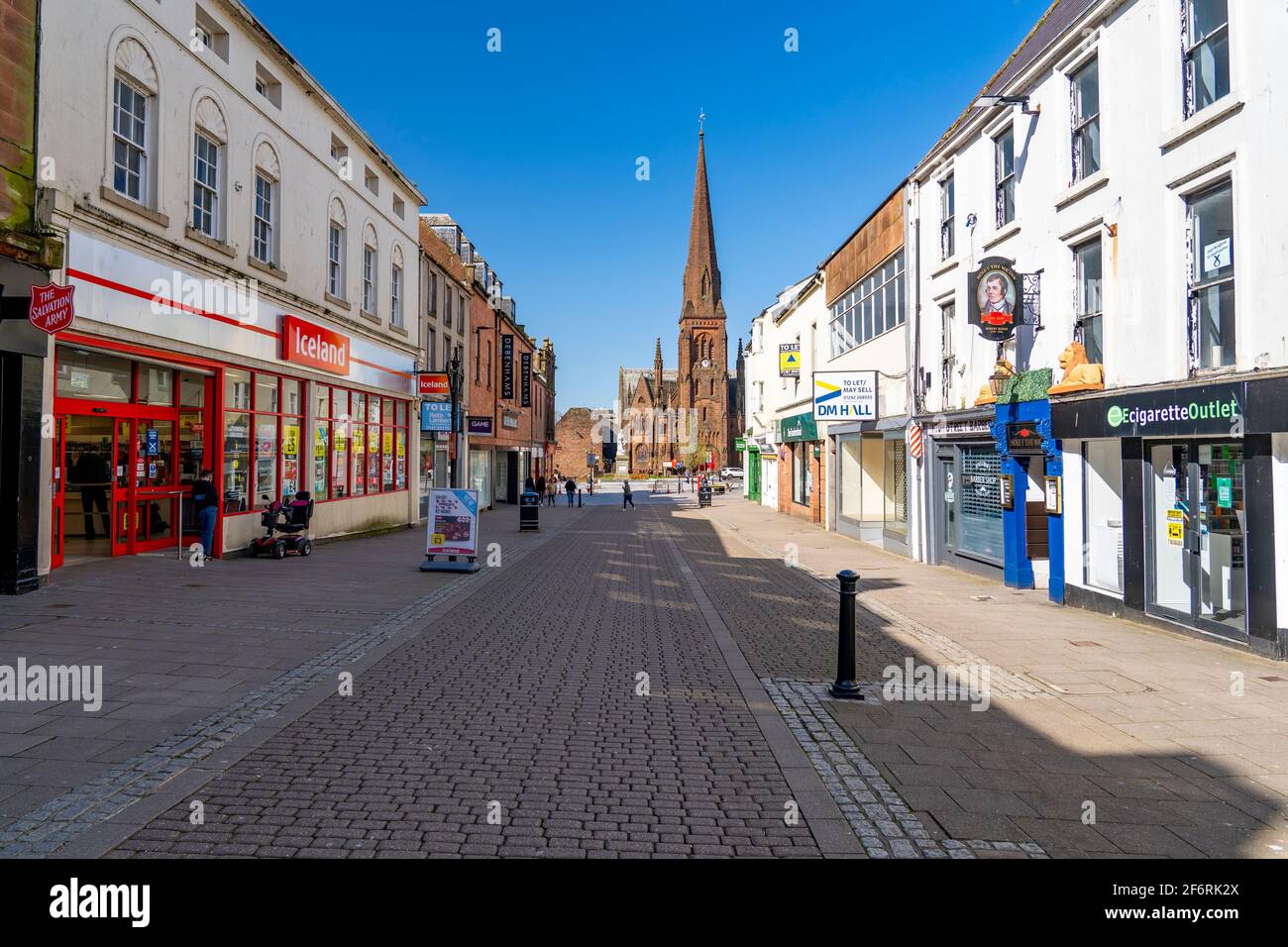 Dumfries, Scotland, UK. 2 April 2021. On the day when Scottish Government relaxes lockdown rules from “Stay at Home” to “Stay Local” the shopping streets of Dumfries town centre remain almost deserted with virtually no shops or businesses trading. Pic;  High Street is very quiet despite the sunny spring weather. Iain Masterton/Alamy Live News Stock Photo